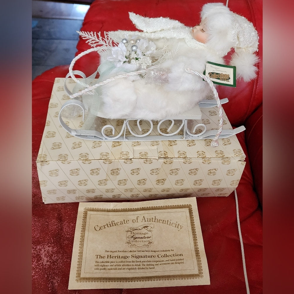 NIB HERITAGE SIGNATURE COLLECTION PORCELAIN DOLL IN SLEIGH WINTER BABY CHARITY